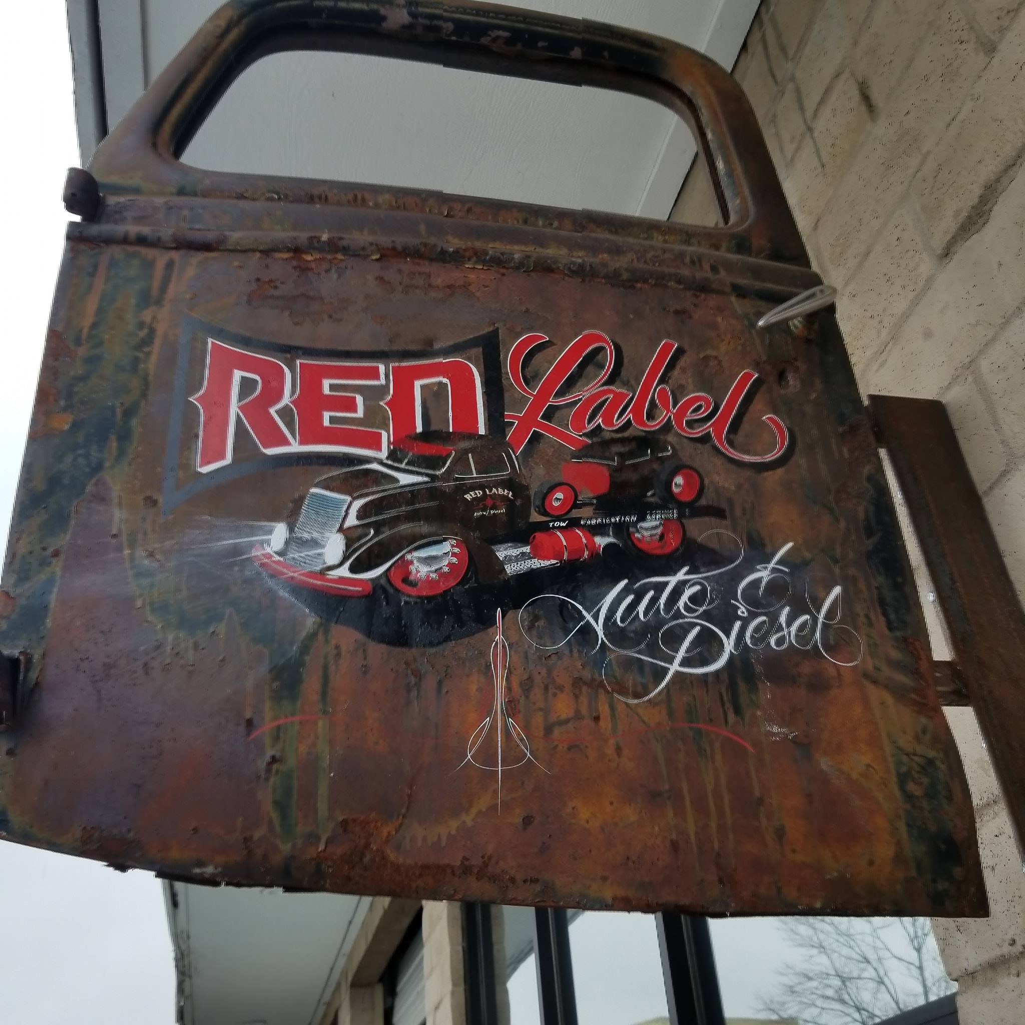 Red Label Automotive & Diesel logo on shop truck door